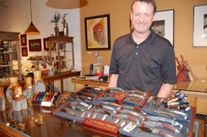 Carefree Buffalo owner Joe Surges with a selection of William Henry knives at the 2012 show