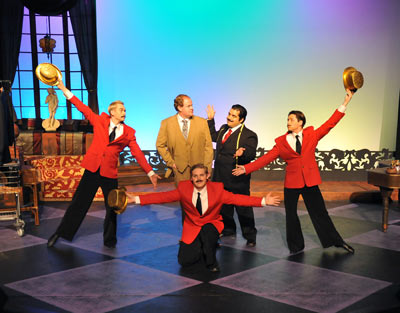  Joe Gibbs (Nathan Monk - center left) is fitted with an expensive and lavish new wardrobe, paid for by Norma Desmond, by expensive tailor Manfred (Erny Rosales - center right), and salesmen (L to R: Joey Larimer, Zane Taylor & Reese Rush) in an elaborately choreographed song and dance number. Photo: Steve Sutfin