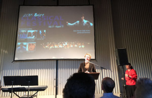Britt Classical Conductor Teddy Abrams at podium discussing 2015 Britt Classical Festival during Season Announcement Party