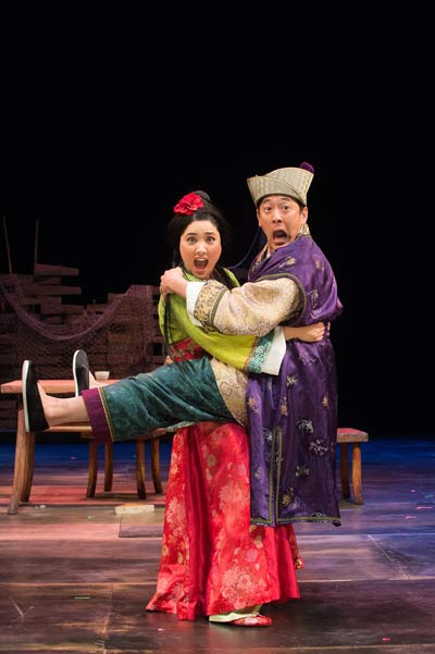 Blossom (Leah Anderson) and Master Yuan (Paul Juhn) in a compromising position in OSF’s Secret Love In Peach Blossom Land