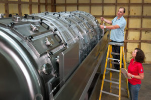 Winemaker Chris Graves and COO Laura Naumes unwrapping the new press at Naumes Crush and Fermentation in Medford.