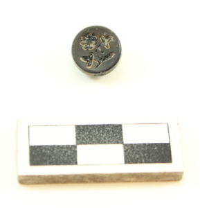Mourning button found at the historic Booker House (scale in centimeters).