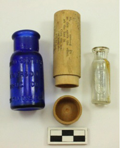 From Left: Cobalt blue Bromo-Seltzer bottle, and a Dr. B. Hunt’s Corn Treatment bottle and wooden case.