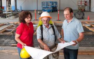 COO Laura Naumes and Winemaker Chris Graves (right) look over plans for Naumes Crush and Fermentation with Kyle White, project manager.