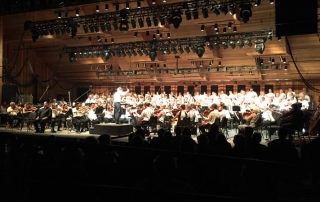 Maestro Teddy Abrams leads the Britt Orchestra, Southern Oregon Repertory Singers, Rogue Valley Chorale, and Baritone soloist Hugh Russell (seated front) in a performance of Carl Orff's Carmina Burana on Opening Night of the Britt Classical Festival, on July 31, 2015 at Jacksonville, OR.