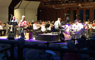 Guest artists clarinetist Johnny Teyssier, bassoonist Harrison Hollingswood, and drummer Gabriel Globus Hoenich with Teddy Abrams on piano (collectively, Sixth Floor Trio) at the front of the stage, as the Britt Orchestra, directed by Mr. Abrams, accompanies in the performance of Louis Prima's Sing, Sing, Sing, on August 8, 2015 in Jacksonville, OR.