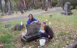 Headstone cleaning by Michele Simmons and her daughter Ruby. Photo by Mary Siedlecki.