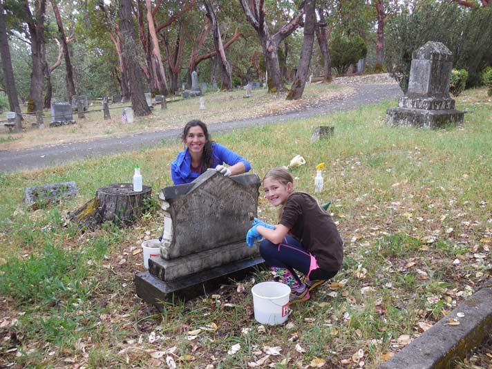 Headstone cleaning by Michele Simmons and her daughter Ruby. Photo by Mary Siedlecki.
